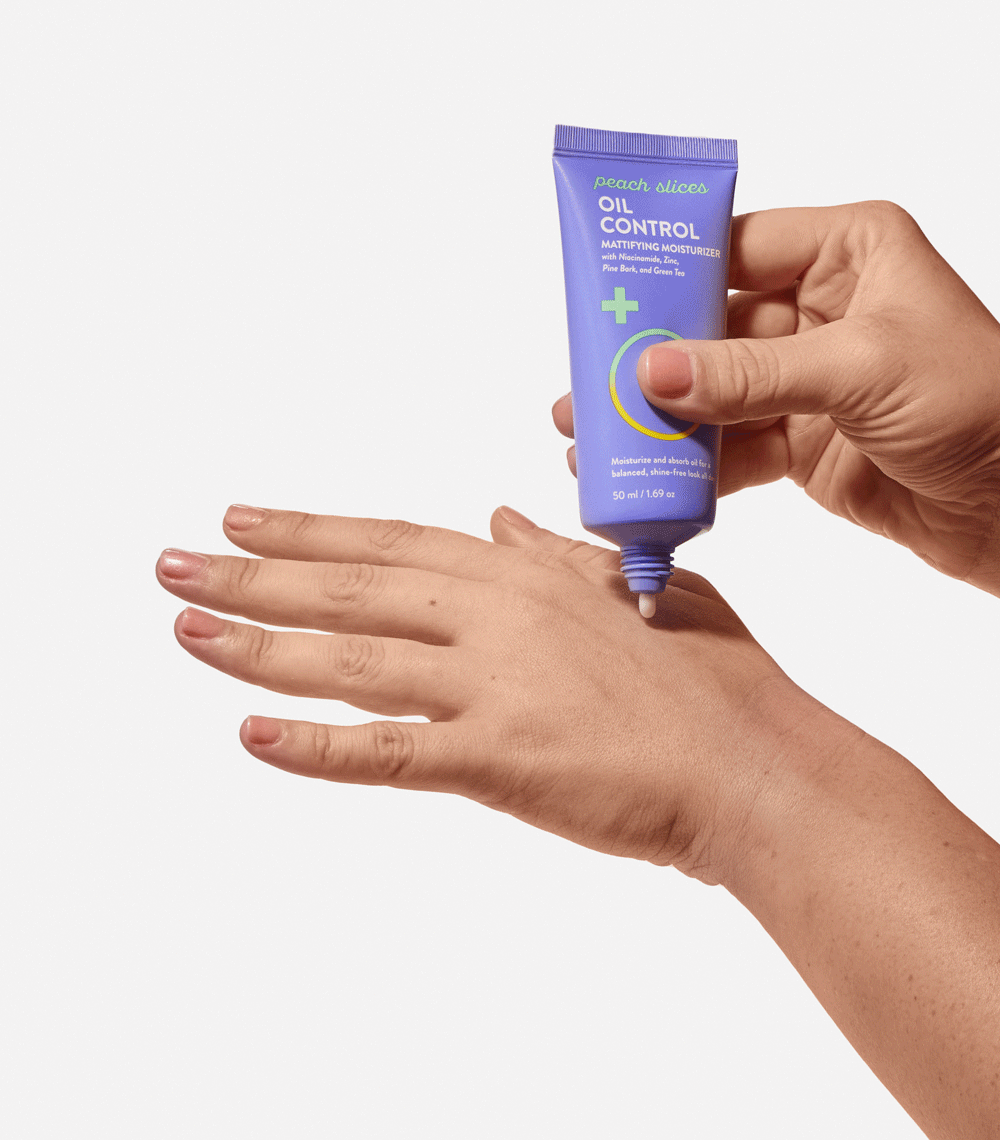 Someone applies Oil Control Mattifying Moisturizer to the back of their hand and rubs it in, showing the easy application and smooth texture of the product