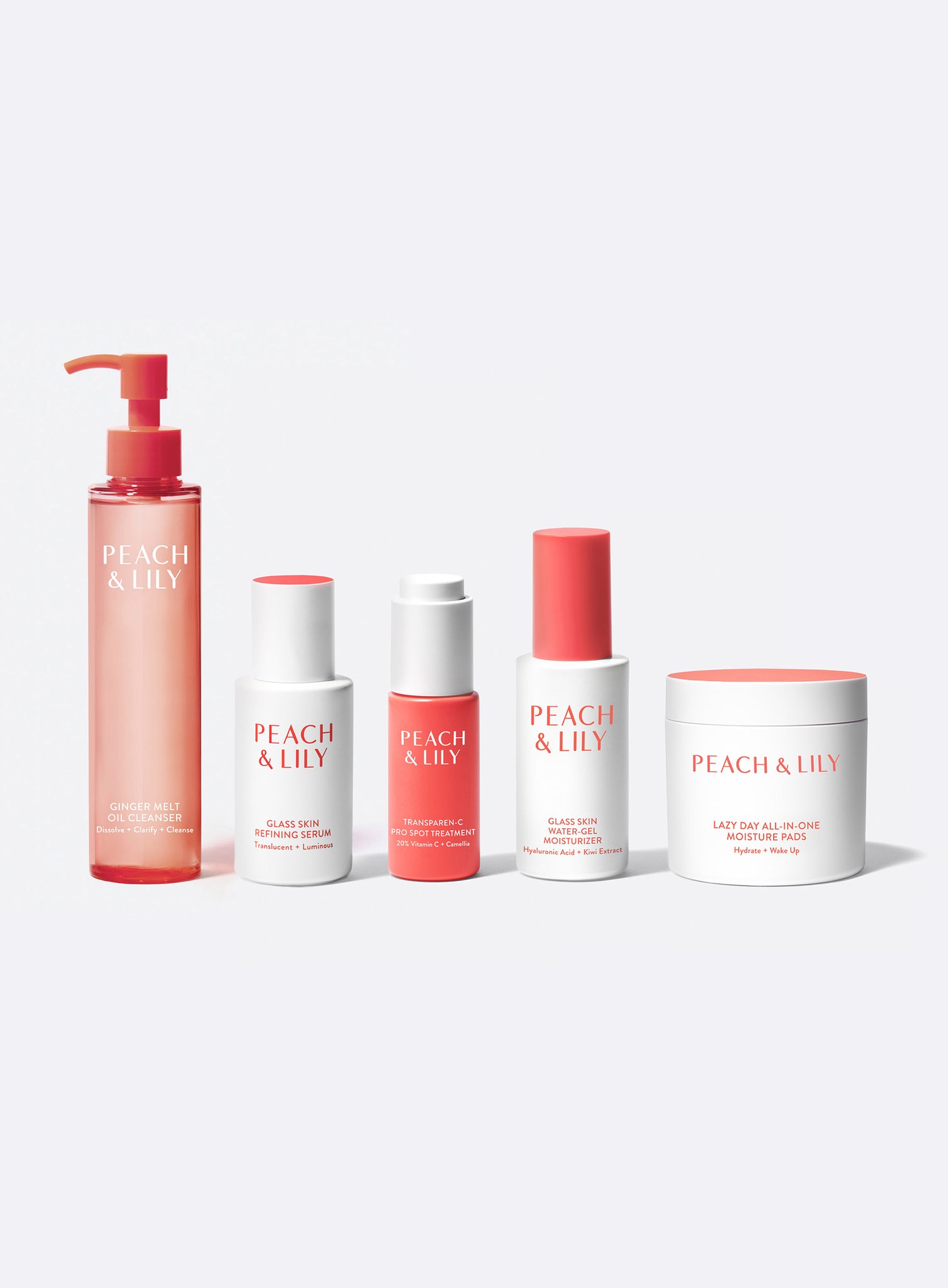 A line up of the products included in the Peach & Lily Peach Fuzz Kit for pregnancy and postpartum skin health including Ginger Melt Oil Cleanser, Glass Skin Refining Serum, Transparen-C Pro Spot Treatment, Glass Skin Water Gel Moisturizer, and Lazy Day All-in-One Moisture Pads