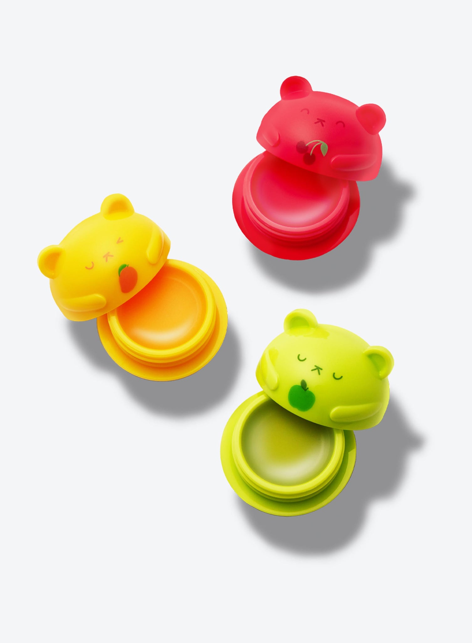 The Beary Merry Lip Balm bear containers open to show the lip balm inside, which is applied with a finger