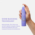 Someone holding a bottle of Peach Slices Oil Control Balancing Mist, highlighting the shine-blocking technology that reduces shine and addresses the root causes of excess oil production