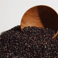 A bowl of spilled over black rice, the star ingredient of Haruharu Wonder Black Rice Facial Oil
