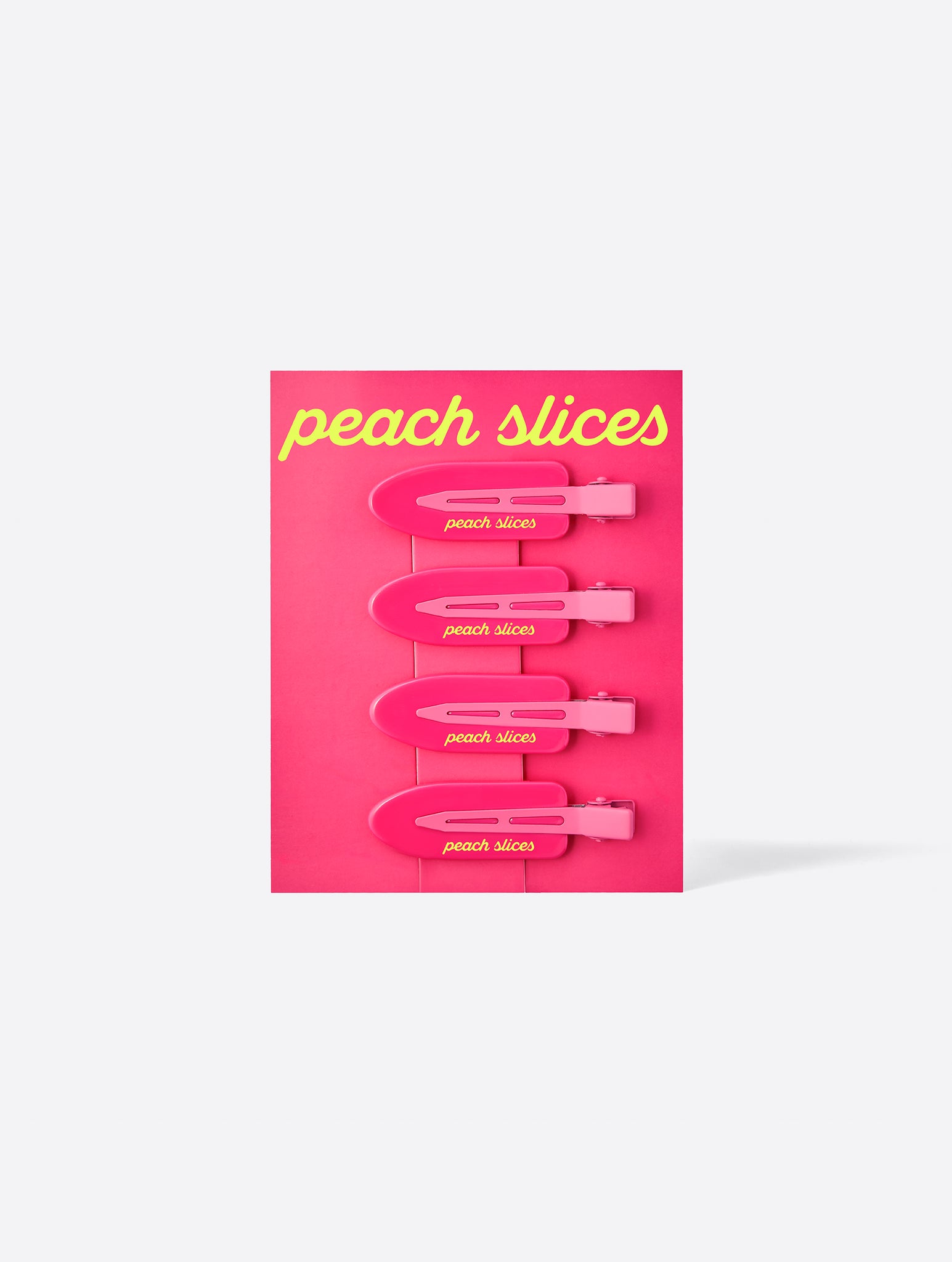 Peach Slices pink packaging with four Creaseless Hair Clips